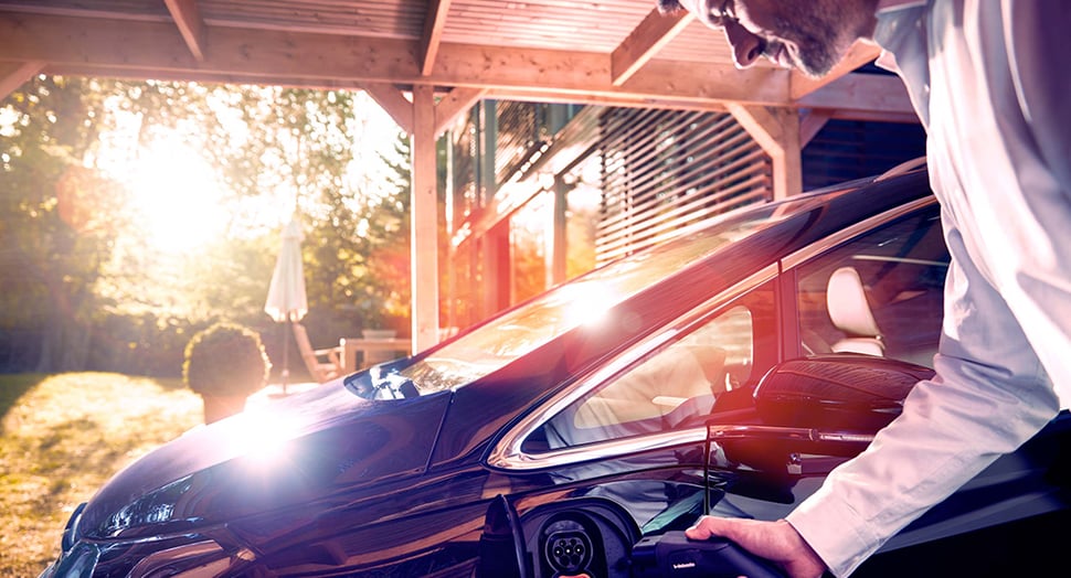 Man Using Home EV Charger