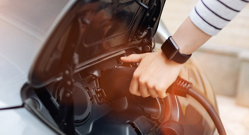 Person charging Nissan Leaf