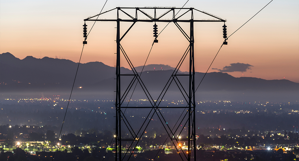 Power Grid Power Lines above city at dusk