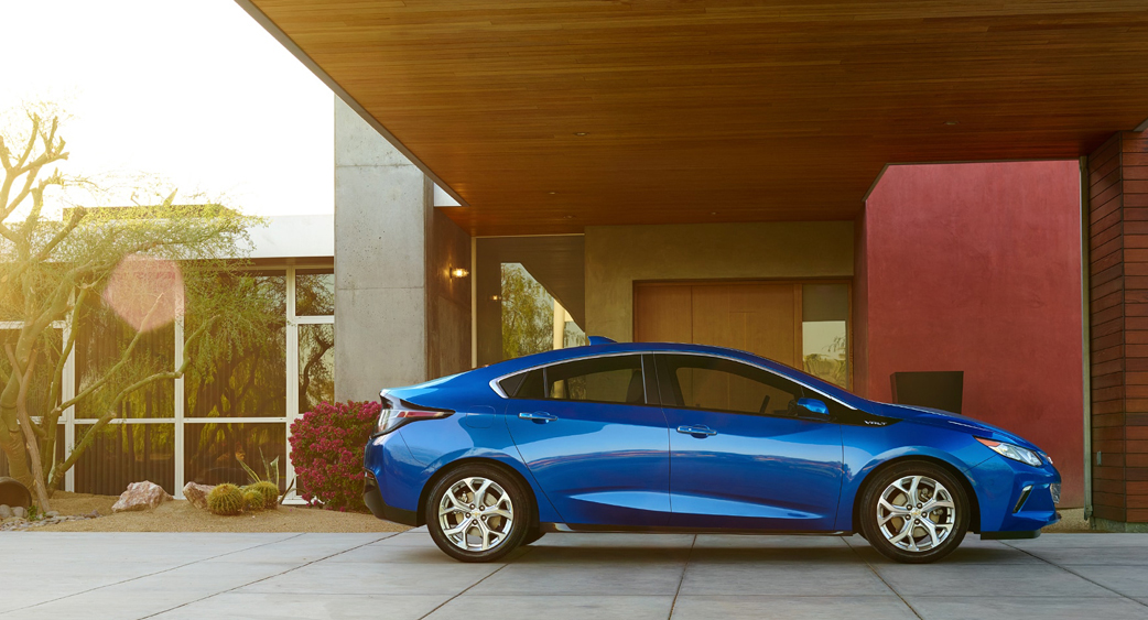 Blue Chevy Volt EV parked in home car port